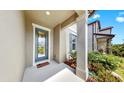 Welcoming front porch with decorative door and lush landscaping at 9293 Rally Spring Loop, Wesley Chapel, FL 33545