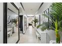Bright hallway decorated with modern art and decorative plants at 10233 Opaline Sky Pl, Riverview, FL 33578