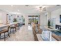 Bright, open-concept living room with neutral tones, sleek modern furniture, and access to the outdoor patio at 10381 Tupper Cay Dr, San Antonio, FL 33576