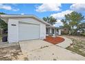 This single Gathering home has an attached garage with a new concrete driveway at 11130 White Oak Ln, Port Richey, FL 34668