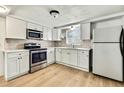 The renovated kitchen boasts modern stainless appliances and new cabinets at 11130 White Oak Ln, Port Richey, FL 34668