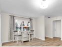 Bright dining area with modern flooring and a charming breakfast table, illuminated by natural light from the nearby window at 12946 116Th St, Largo, FL 33778
