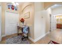 Welcoming front foyer with decorative table and neutral wall color at 13238 Chipout Ln, Hudson, FL 34669