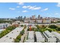 Aerial view showcases the modern townhomes with the city skyline in the distance, under a sunny sky at 1330 W Gray St # 1, Tampa, FL 33606