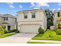 Charming two-story home with a two-car garage, manicured lawn, and welcoming curb appeal at 13686 Whiskey Daisy Dr, Dade City, FL 33525