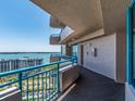 Condo balcony showcasing blue railings and views of the bay and surrounding cityscape at 1520 Gulf Blvd # 1505, Clearwater Beach, FL 33767