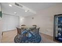 Charming dining area featuring a glass table and seating for four, adjacent to a storage closet at 17710 Gulf Blvd # 304, Redington Shores, FL 33708