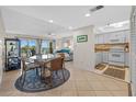 Inviting living area with balcony access, offering views and seamless flow to the kitchen and dining space at 17710 Gulf Blvd # 304, Redington Shores, FL 33708