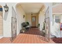 Charming front porch with tile flooring, gated entry, and plenty of space for seating at 202 Grayson Ct, Sun City Center, FL 33573
