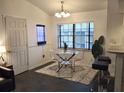 Bright dining area featuring a glass table, modern chairs, and a contemporary light fixture at 21103 Patio View Ct # 3302, Lutz, FL 33558