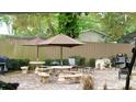 Charming outdoor patio area with stone pavers, umbrellas, and an array of seating options at 21103 Patio View Ct # 3302, Lutz, FL 33558