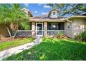 Inviting front porch with brick accents, seating area, and a well-maintained walkway at 2507 Dewberry St, Valrico, FL 33596