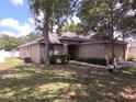 Traditional one-story home with a well-kept lawn, mature trees, and a convenient two-car garage at 2614 Queen Alberta Dr, Valrico, FL 33594