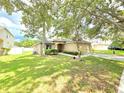 Inviting single-Gathering home with well-maintained lawn and mature trees in a suburban neighborhood at 2614 Queen Alberta Dr, Valrico, FL 33594