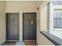 Condo entrance showcasing the unit front doors with visible unit numbers at 2650 Countryside Blvd # A210, Clearwater, FL 33761
