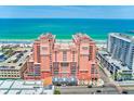 Stunning view of the pink beachfront condo with balconies and ocean view at 301 S Gulfview Blvd # 301, Clearwater Beach, FL 33767