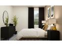 Modern bedroom with dark accents, side tables, large window and artistic decor at 31856 Griffin Sands Ln, San Antonio, FL 33576