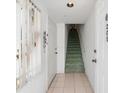 Bright entryway with tile flooring and a staircase leading to the upper level at 320 Island Way # 205, Clearwater Beach, FL 33767