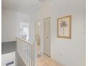 Upstairs hallway with closet and palm tree art at 320 Island Way # 205, Clearwater Beach, FL 33767
