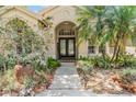 Charming home exterior featuring lush landscaping and a welcoming entrance at 4320 Auston Way, Palm Harbor, FL 34685
