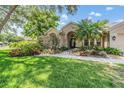 Charming home exterior featuring lush landscaping and a welcoming entrance at 4320 Auston Way, Palm Harbor, FL 34685