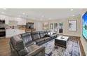 Spacious living room featuring modern decor, an open layout with the kitchen, and access to the outdoor area at 5008 Stolls Ave, Tampa, FL 33615