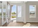 Bright foyer with modern floors and glass door offering a glimpse of the outdoors, creating an inviting entrance at 5116 Wildwind Dr, Apollo Beach, FL 33572