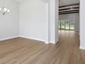 Open-concept floor plan featuring lots of space, stylish light fixture, and a beamed ceiling design at 5116 Wildwind Dr, Apollo Beach, FL 33572