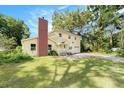 The front of a two-story home with a large yard and a red brick chimney at 6024 90Th N Ave, Pinellas Park, FL 33782