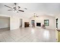 Large living room featuring tile flooring, a fireplace, and ceiling fans for added comfort at 6024 90Th N Ave, Pinellas Park, FL 33782