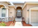 Grand entryway boasting a double-door entry, stone accents, and a welcoming pathway at 6519 Twin Bridges Dr, Zephyrhills, FL 33541