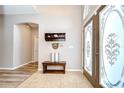 Inviting foyer featuring decorative tiled flooring, bench seating and decorative shelf at 6519 Twin Bridges Dr, Zephyrhills, FL 33541