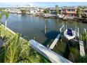 A private dock with a boat lift on a serene canal leads to the Gulf, providing deep water access at 659 Garland Cir, Indian Rocks Beach, FL 33785