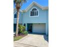 Charming two-story townhome features a one car garage, lovely front yard, and is move-in ready at 659 Garland Cir, Indian Rocks Beach, FL 33785