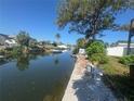 Waterfront view of a canal with boat, greenery and bench seating at 7330 New York Ave, Hudson, FL 34667