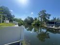 Scenic view of a canal with lush greenery and waterfront homes at 7330 New York Ave, Hudson, FL 34667