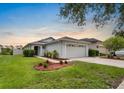 Charming single-story home featuring a two-car garage, well-manicured lawn, and a welcoming front entrance at 816 College Chase Dr, Ruskin, FL 33570