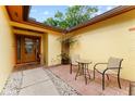 Inviting front patio with comfortable seating, potted plants, and a charming entryway to the home at 8315 W Elm St, Tampa, FL 33615