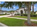 Inviting single-story home with well-maintained landscaping, a three-car garage and meticulous lawn at 8413 Swiss Chard Cir, Land O Lakes, FL 34637