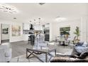 Open concept living area featuring modern light fixtures, gray tones, and backyard views at 9266 Century Dr, Spring Hill, FL 34606