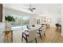 Bright living room with access to the pool area, featuring stylish seating and ample natural light at 970 Ridgewood Ter, Tarpon Springs, FL 34689