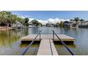Waterfront dock overlooking tranquil canal with views of boats and neighboring houses at 10744 Drummond Rd, Tampa, FL 33615