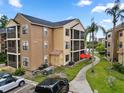 Well-maintained condo building with screened balconies, lush landscaping, and convenient parking at 11901 4Th N St # 5111, St Petersburg, FL 33716