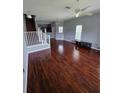 Spacious living room featuring hardwood floors, stairs, and an abundance of natural light at 13157 Kings Crossing Dr, Gibsonton, FL 33534