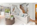 Bright living room with staircase, wood floors, and stylish modern decor at 14134 Trouville Dr, Tampa, FL 33624