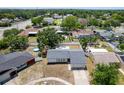 Aerial view showcasing a single-story home with a fenced backyard, surrounded by mature trees and neighborhood streets at 1818 Willow Oak Dr, Palm Harbor, FL 34683