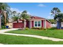 Landscaped home boasts beautiful lawn, front garden, and exterior color scheme at 19635 Bellehurst Loop, Land O Lakes, FL 34638