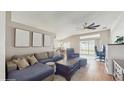 Spacious living room with comfortable seating, modern ceiling fan, and sliding glass doors to the backyard at 19635 Bellehurst Loop, Land O Lakes, FL 34638
