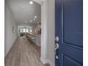 Bright entryway with wood-look tile leading into the open-concept living space at 212 Villa Luna Ln, Lutz, FL 33549