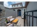 Inviting outdoor seating on a stylish brick patio with a modern seating arrangement at 212 Villa Luna Ln, Lutz, FL 33549